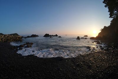 Scenic view of sea against clear sky during sunset