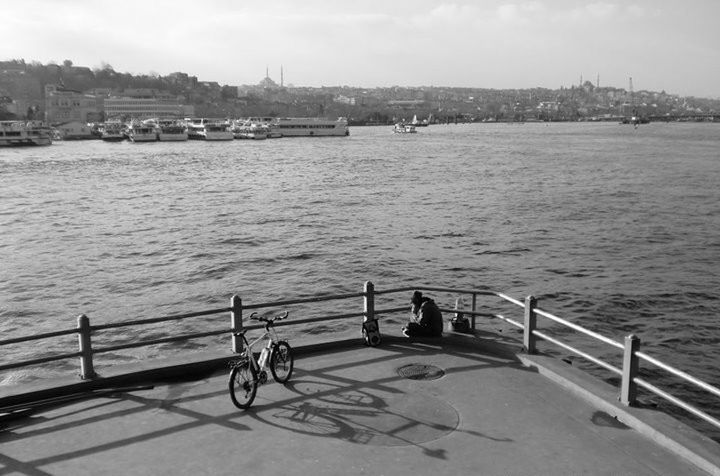 water, transportation, mode of transport, sea, railing, nautical vessel, built structure, sky, architecture, building exterior, river, city, bicycle, boat, rippled, day, men, pier, travel