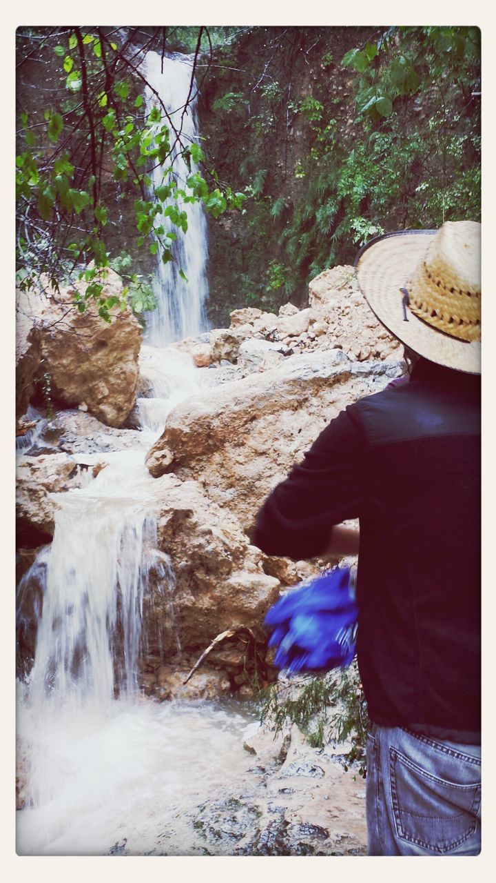 water, transfer print, motion, waterfall, tree, auto post production filter, flowing, flowing water, rock - object, rear view, lifestyles, long exposure, leisure activity, forest, nature, men, beauty in nature, outdoors