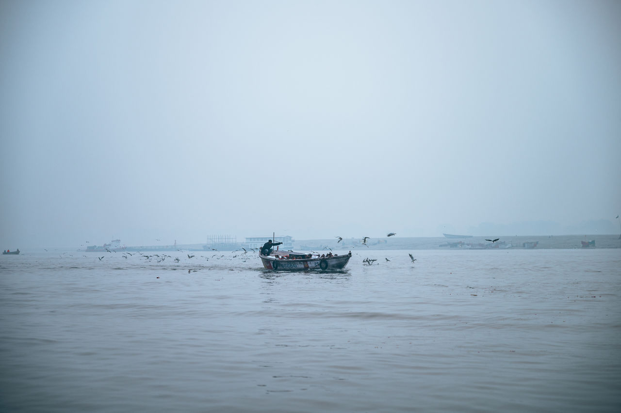 water, nautical vessel, sea, transportation, mode of transportation, sky, nature, wave, ocean, horizon, shore, reflection, morning, tranquility, ship, scenics - nature, day, beauty in nature, horizon over water, travel, tranquil scene, vehicle, outdoors, copy space, clear sky, beach, no people, boat, environment, coast, vignette, land, body of water