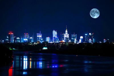 View of illuminated cityscape against sky at night