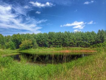 Scenic view of lake against cloudy sky