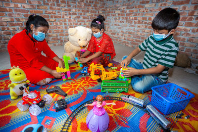 Rear view of a boy playing with toy