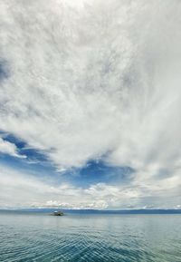 Scenic view of sea against cloudy sky