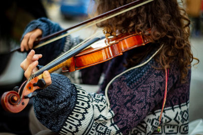 Close-up of woman playing violin