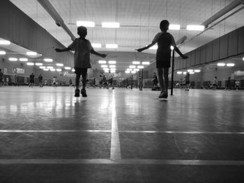 Rear view of boys doing jumping rope