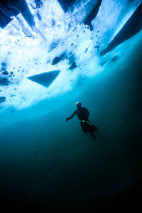 Low angle view of scuba diver underwater