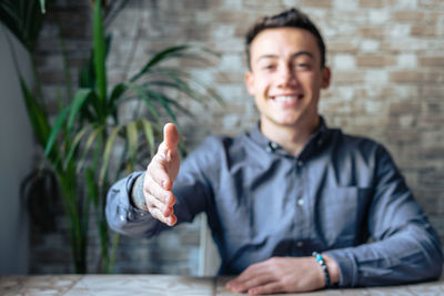 Portrait of young man sitting at home