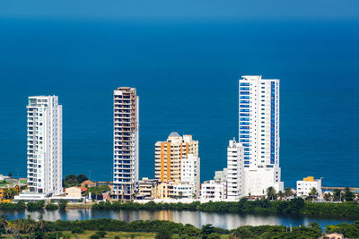 Tall modern buildings against sea