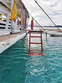 Reflection of built structure in swimming pool against sky