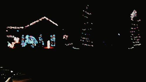 Low angle view of illuminated lights at night