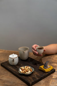 Midsection of woman having breakfast on table
