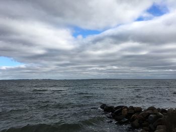 View of calm sea against cloudy sky