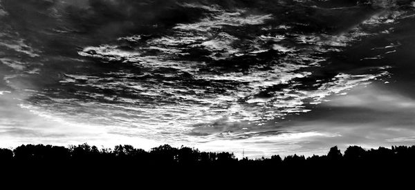 Scenic view of silhouette trees against sky at sunset