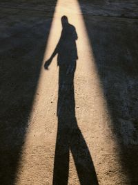 Shadow of person standing on road