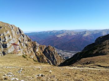 Scenic view of mountains against clear blue sky