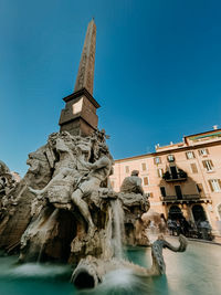 Low angle view of historical building against clear blue sky
