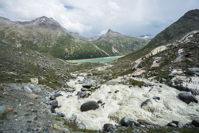 Scenic view of river flowing through valley against mountain range