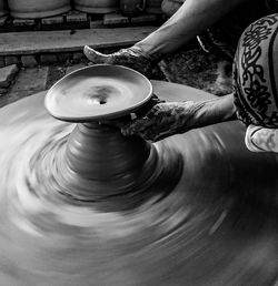 Cropped hands of worker making pottery in workshop