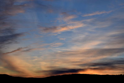 Scenic view of dramatic sky at sunset