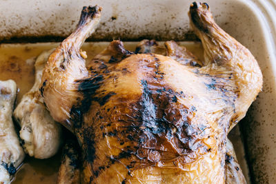 High angle view of roasted chicken in tray