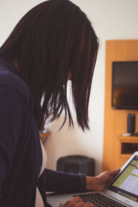 Woman using laptop at home