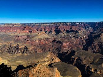 View of rock formations against blue sky