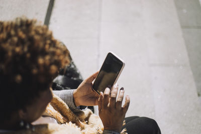 Senior woman using smart phone during sunny day