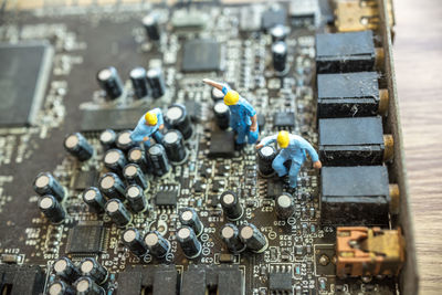 Close-up of figurines on mother board