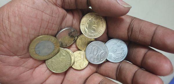 Close-up of hand holding coins