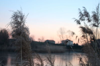 Scenic view of lake against clear sky at sunset