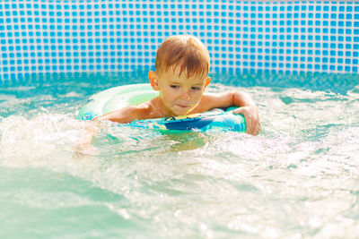 Portrait of boy swimming in pool