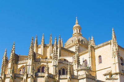 Low angle view of buildings against blue sky