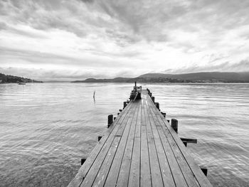 Pier over lake against sky