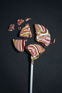 Close-up of cake against black background