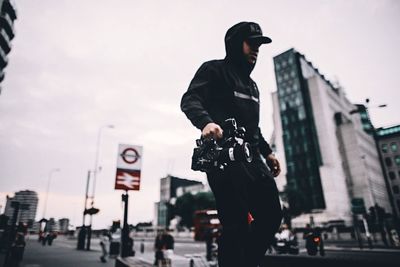 Low angle view of man standing in front of building