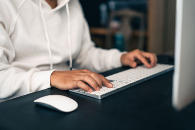 Midsection of woman using laptop