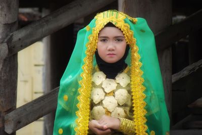 Portrait of beautiful young woman standing at home