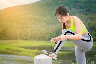 Young woman with arms raised