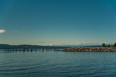 Scenic view of sea against clear blue sky