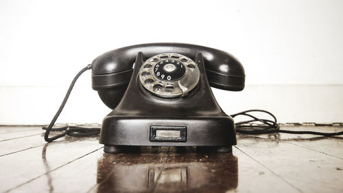 Close-up of old telephone on table