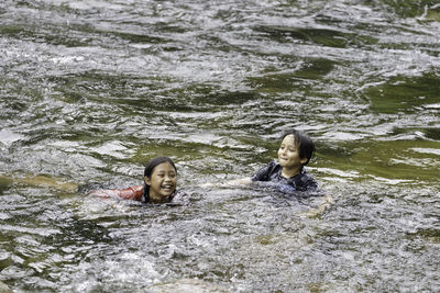 Portrait of two people swimming in water