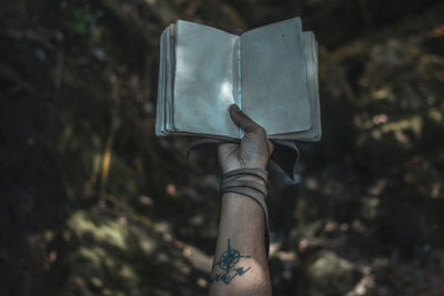 Close-up of hand holding book