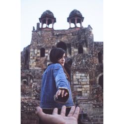 Man looking at old building