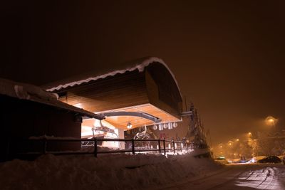 Snow covered houses at night