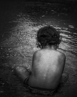 High angle view of woman sitting in water