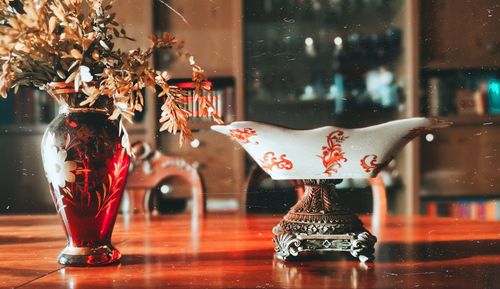 Flower vase with decoration on table