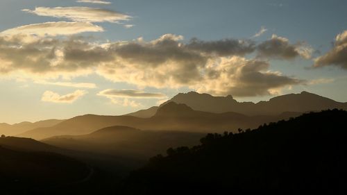 Scenic view of silhouette mountains against sky at sunset