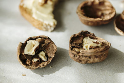 Open nuts split in half on a ceramic plate