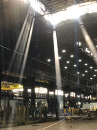 People walking on illuminated street at night